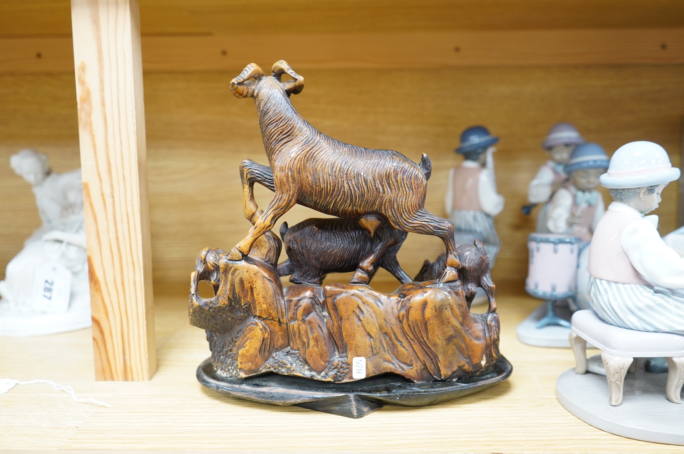 A Chinese carved soapstone figure group of goats on hardwood base, 24cm. Condition - fair to good